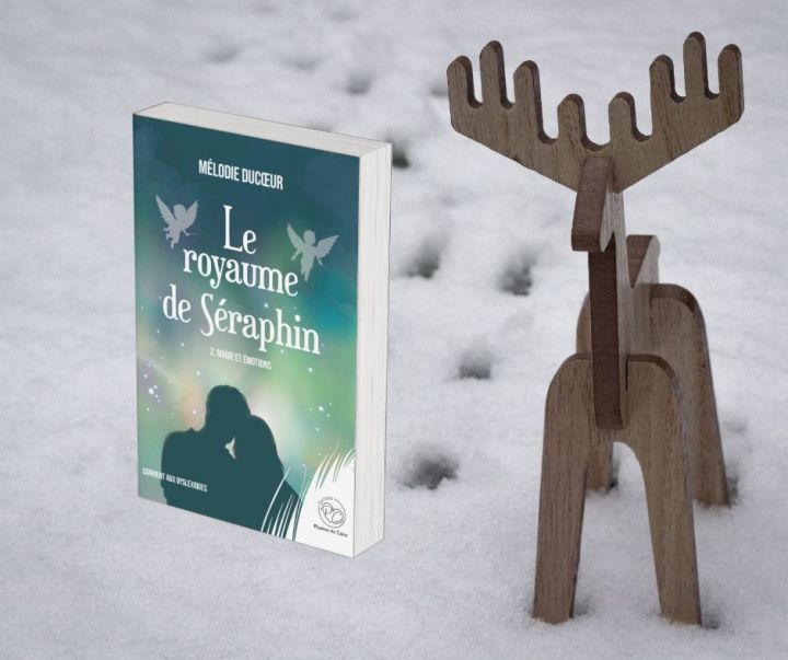 un renne en bois dans la neige et à côré le roman le royaume de Séraphin 2. magie et émotions